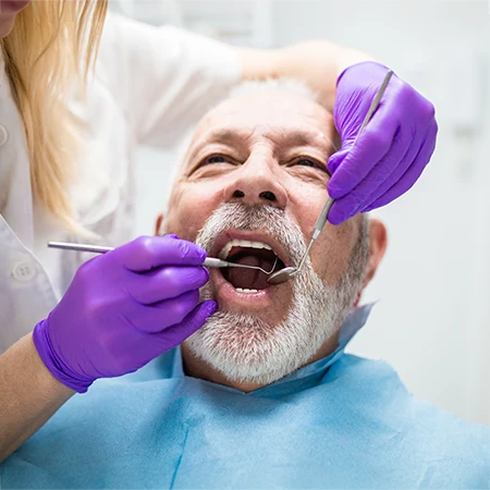 Dentist Sacramento CA Performing Dental Care On Patient